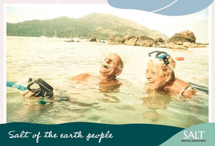 Elderly Couple Snorkelling In The Ocean